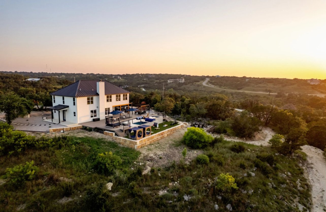 outdoor custom hardscape patio with stone retaining walls & artificial turf